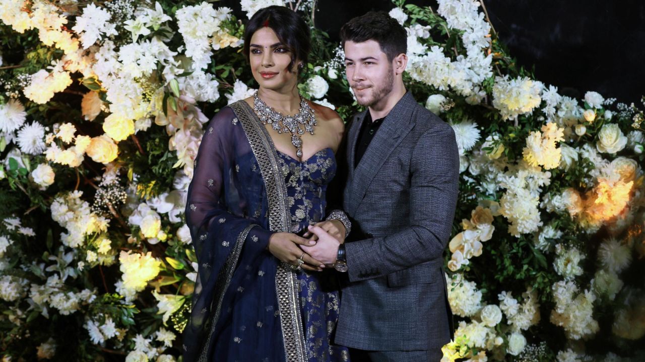 Actress Priyanka Chopra and musician Nick Jonas pose for photos during a reception in Mumbai, India, on Wednesday, December 19. <a href="https://www.cnn.com/2018/12/04/entertainment/priyanka-chopra-nick-jonas-wedding-photos/index.html" target="_blank">The two were married</a> earlier this month.