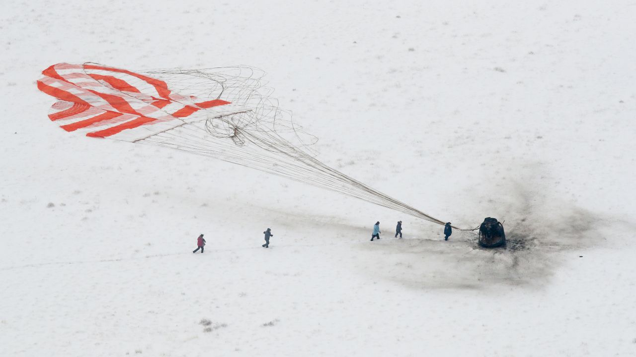 A search-and-rescue team approaches the Soyuz space capsule that had just landed in a remote area of Kazakhstan on Thursday, December 20. Aboard the capsule were three astronauts returning from the International Space Station.