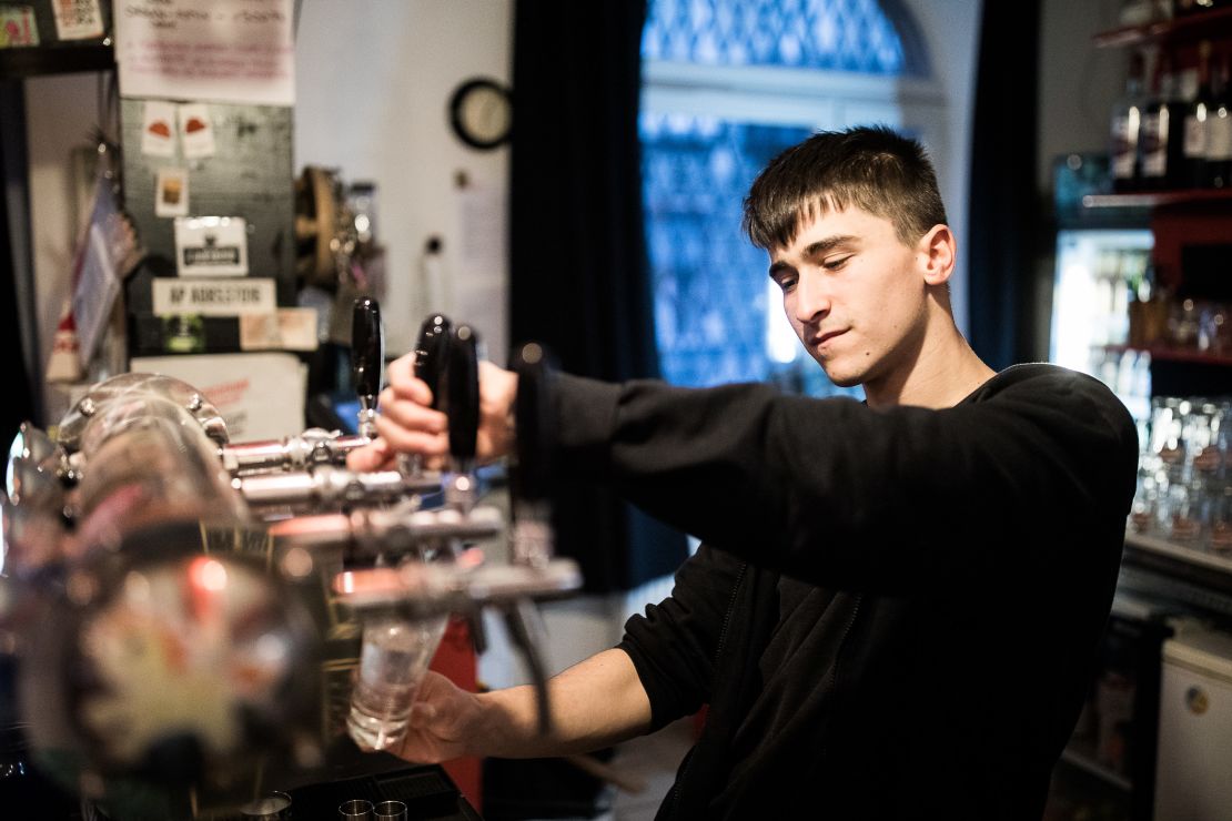A barman pours a beer at the Aurora.