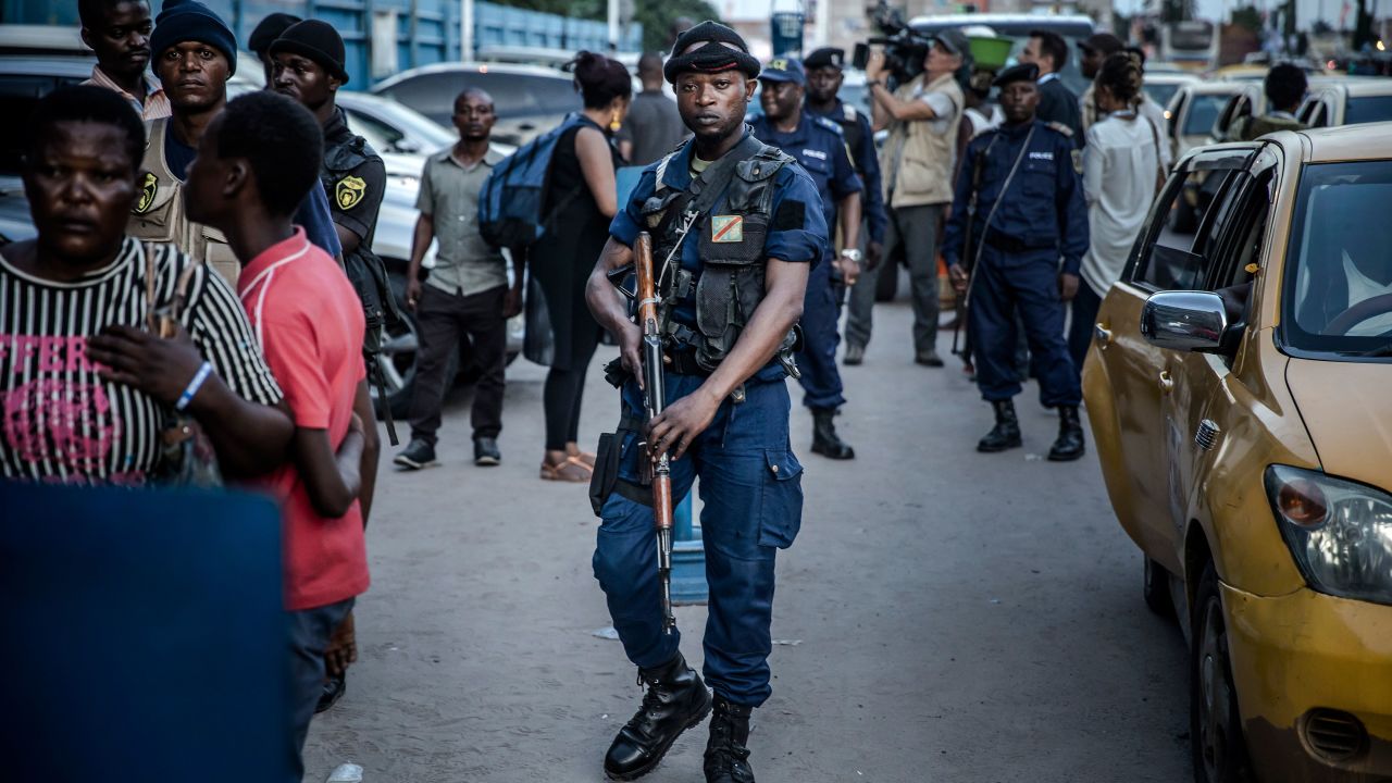 Police patrol outside the election commission headquarters in Kinshasa.