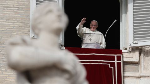 Pope Francis waves to the faithful in St. Peter's Square, at the Vatican.
