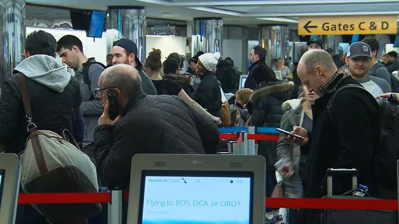Travelers wait in line Friday at New York's LaGuardia Airport as a storm was expected to bring delays.