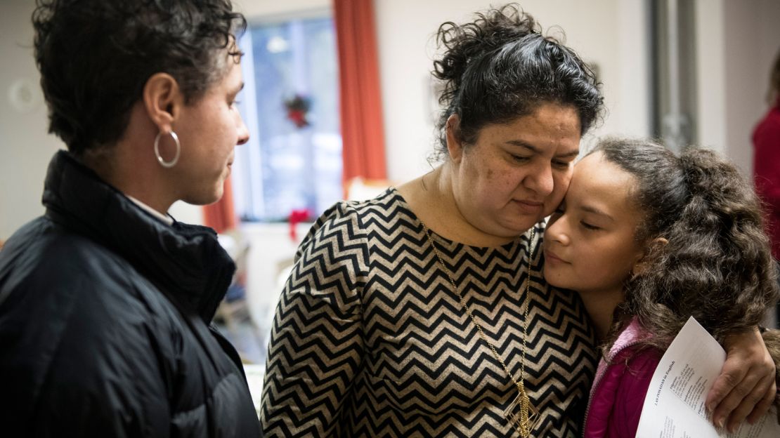 Amid festive preparations for a celebration just days before Christmas, Samuel's recent deportation comes up and the mood turns somber. "We didn't expect such bad news," Juana says as her granddaughter Koral Bridguett leans in to comfort her. 