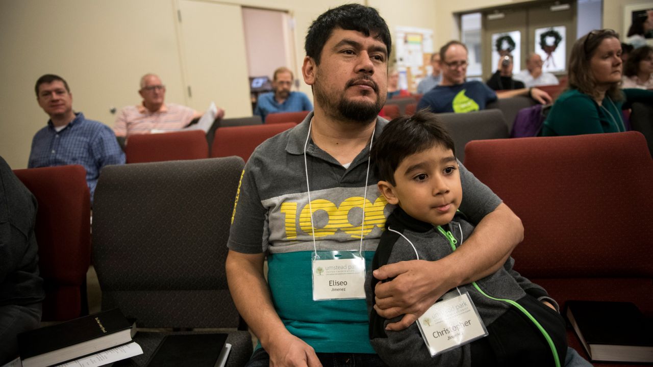 Eliseo Jimenez and his 5-year-old son Christopher watch a worship service at Umstead Park United Church of Christ in Raleigh. Jimenez, 40, has been living in the church since October 2017.