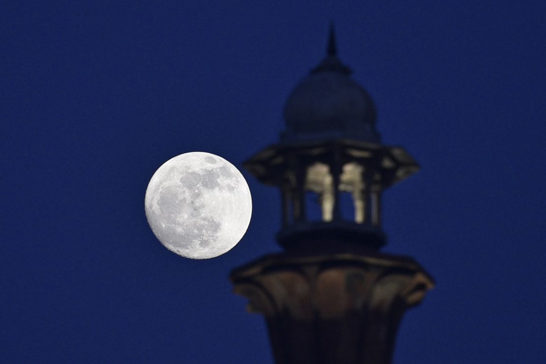 The Cold Moon is seen at the Red Fort in New Delhi, India, on Friday evening.