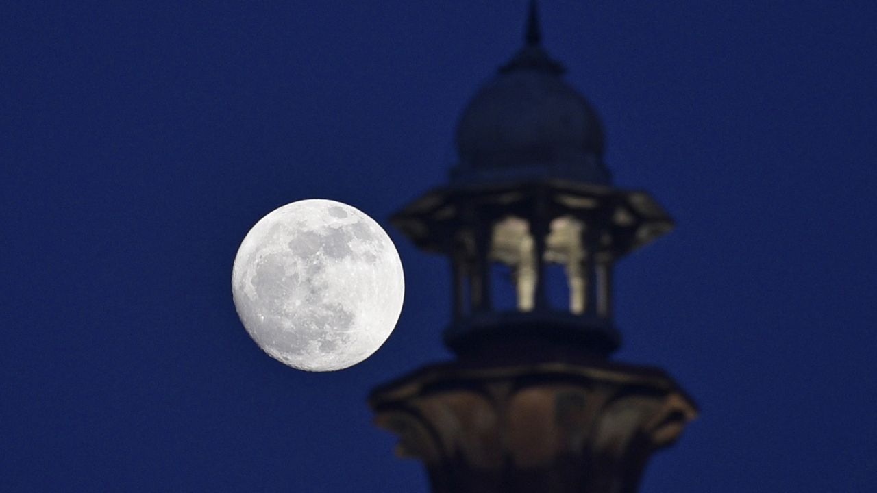 The Cold Moon is seen at the Red Fort in New Delhi, India, on Friday evening.
