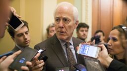 Senate Majority Whip John Cornyn, a Republican from Texas, speaks to members of the media outside his office at the U.S. Capitol in Washington, D.C., U.S., on Friday, Dec. 21, 2018. The federal government is on the brink of a partial shutdown starting Friday night with Congress at an impasse with President Donald Trump over his demands to fund a wall on the U.S.-Mexico border. 