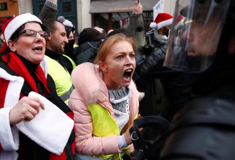 Protesters confront police during a "yellow vest" demonstration Saturday, December 22, in central Paris.