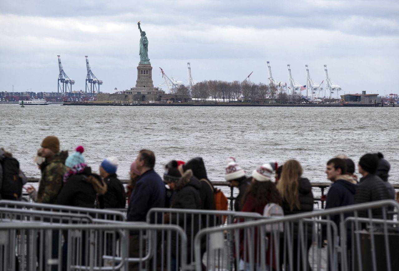 People line up to board a ferry to visit the Statue of Liberty on December 22. The national landmark remained open after New York Gov. Andrew Cuomo made funding available for it.
