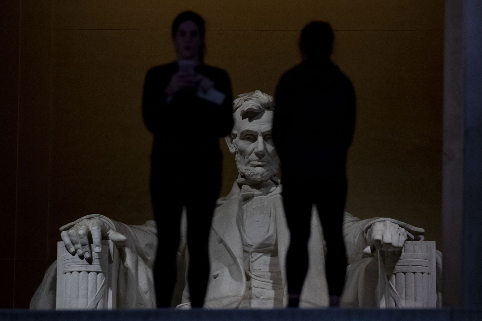 Two people stand in front of the Lincoln Memorial on Saturday, December 22. Many of the National Mall sights remained open despite the shutdown.