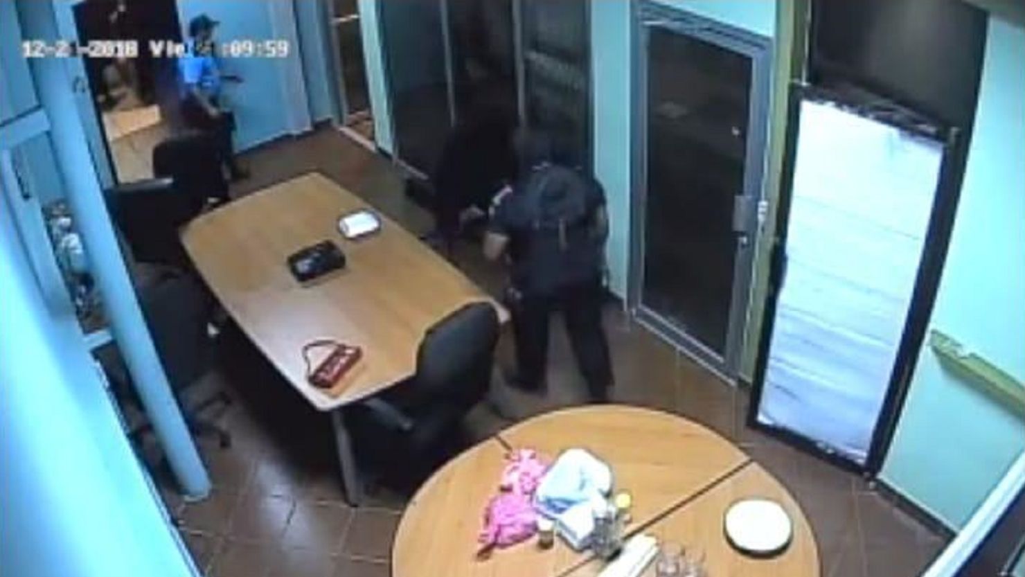 Security camera footage shows law enforcement walking inside the TV station Friday night.