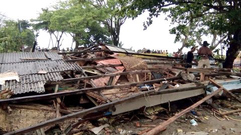 Residents inspect the damage to their homes on Carita beach on December 23.