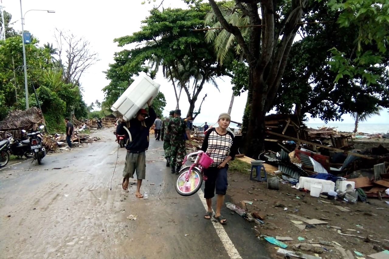 Residents evacuate from damaged homes.