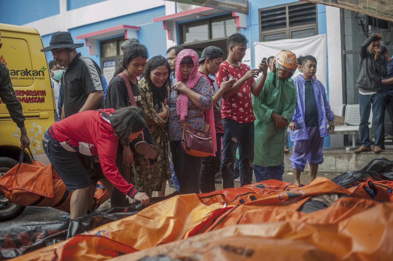 People search for relatives among the bodies of tsunami victims. 