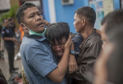 A man breaks down after identifying his relative among the bodies of tsunami victims in Carita, Indonesia, on Sunday.