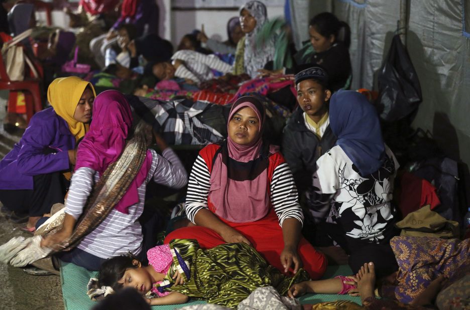 Tsunami survivors gather at temporary shelter in Tanjung Lesung, Indonesia, on Sunday.