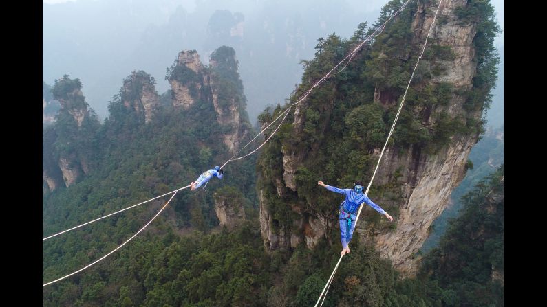 Contestants dressed as characters from the movie "Avatar" take part in a tightrope walking contest on December 23 in Zhangjiajie, Hunan province, China.