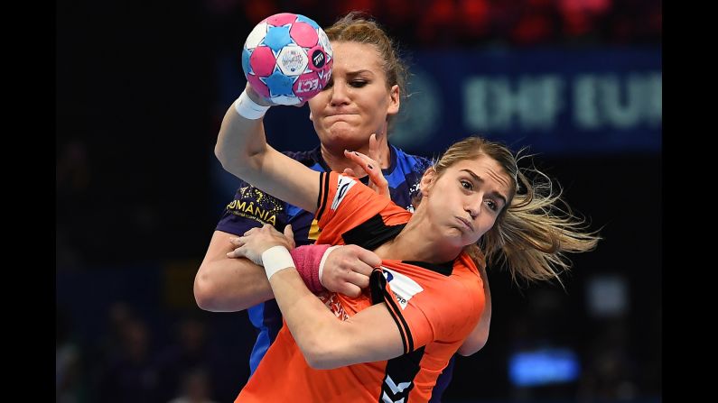 Romania's Crina Elena Pintea (back) battles with Estavana Polman of the Netherlands during the EHF EURO European Women's Handball Championship third place match at the AccorHotels Arena in Paris on December 16.