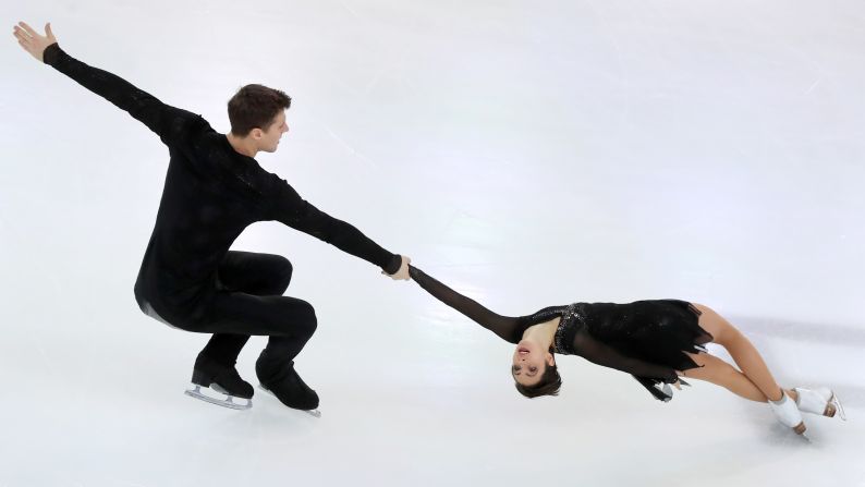 Figure skaters Natalya Zabiyako and Alexander Enbert perform a death spiral during a pairs free skating event at the 2019 Russian Figure Skating Championships.