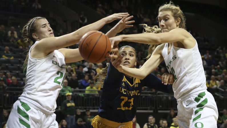 Oregon's Sabrina Ionescu, left, and Lydia Giomi, right, battle UC Irvine's Tahlia Garza, center, for a rebound during the second half of an NCAA college basketball game in Eugene, Oregon on Friday, December 21.