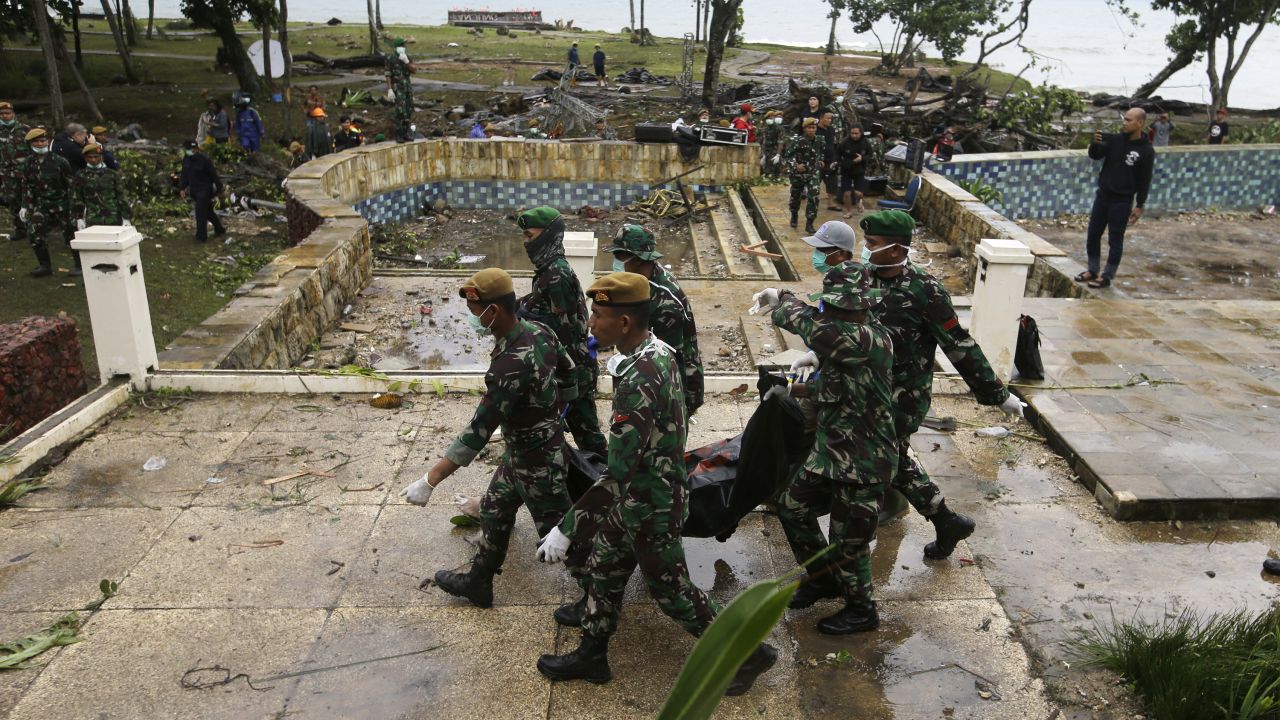 Indonesian soldiers carry the bodies of tsunami victims at a beach resort in Tanjung Lesung, Indonesia, on Monday.