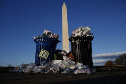 A public trash can spills over on Washington's Pennsylvania Avenue on Monday, December 24.