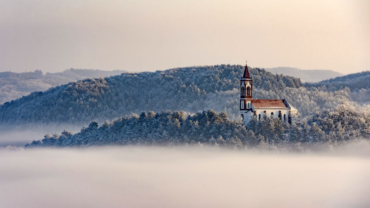 <strong>Soshartyan, Hungary:</strong> As December temperatures fall below 0 Celsius (32 F), a church stands above a layer of fog in the Hungarian village of Soshartyan. <br />