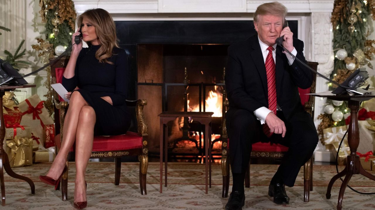 The Trumps answer calls from people to the NORAD Santa tracker phone line Monday at the White House. 