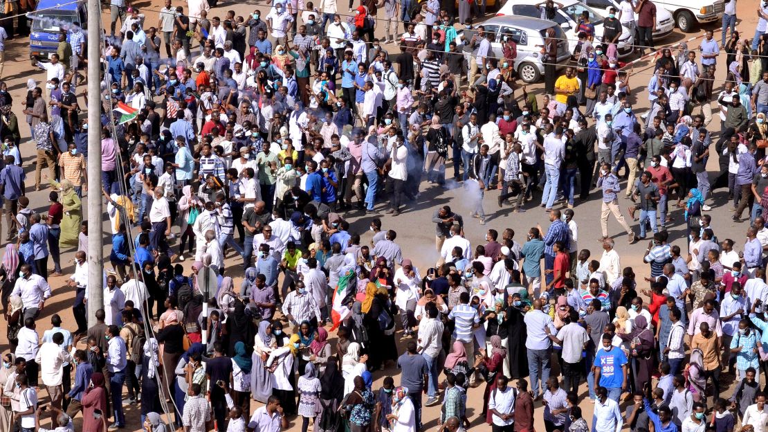 Anti-government protestors eject a teargas canister lobbed to disperse them as they march along the street during anti-government protests in Khartoum, Sudan on Tuesday.