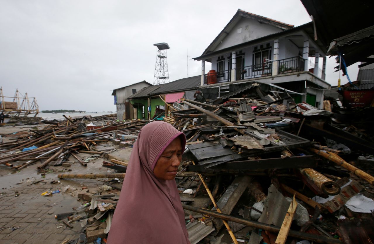 A tsunami survivor walks around Sumur on Tuesday.