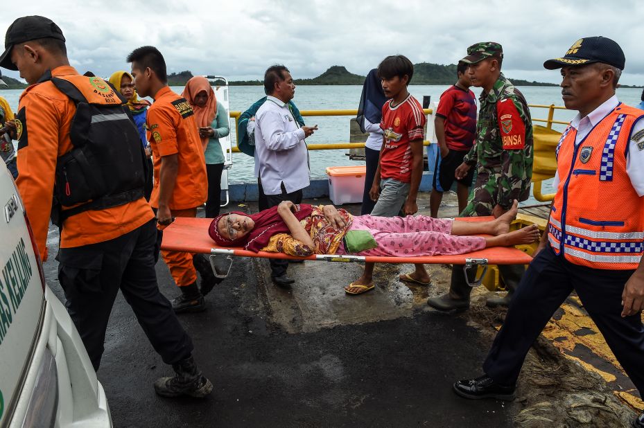Members of an Indonesian search and rescue team carry an elderly woman on a stretcher at the ferry port after being evacuated from Sebesi Island, in Bakauheni, on Wednesday.