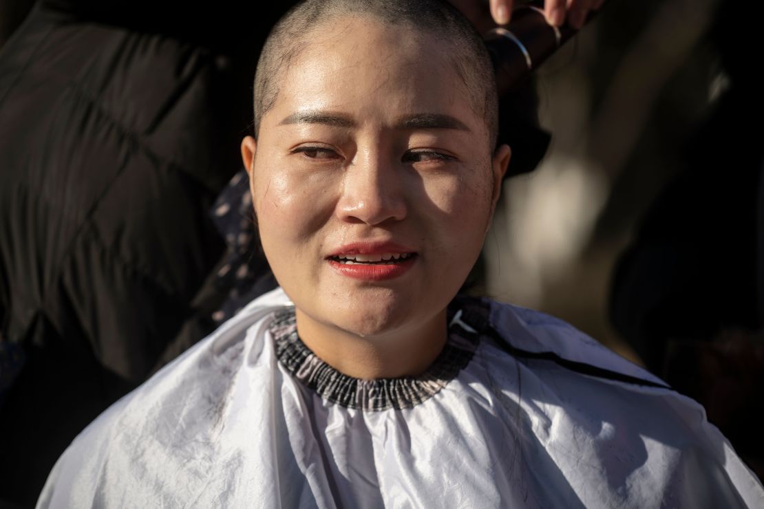 Li Wenzu has her head shaved to protest the detention of her husband and Chinese human rights lawyer Wang Quanzhang on December 17.