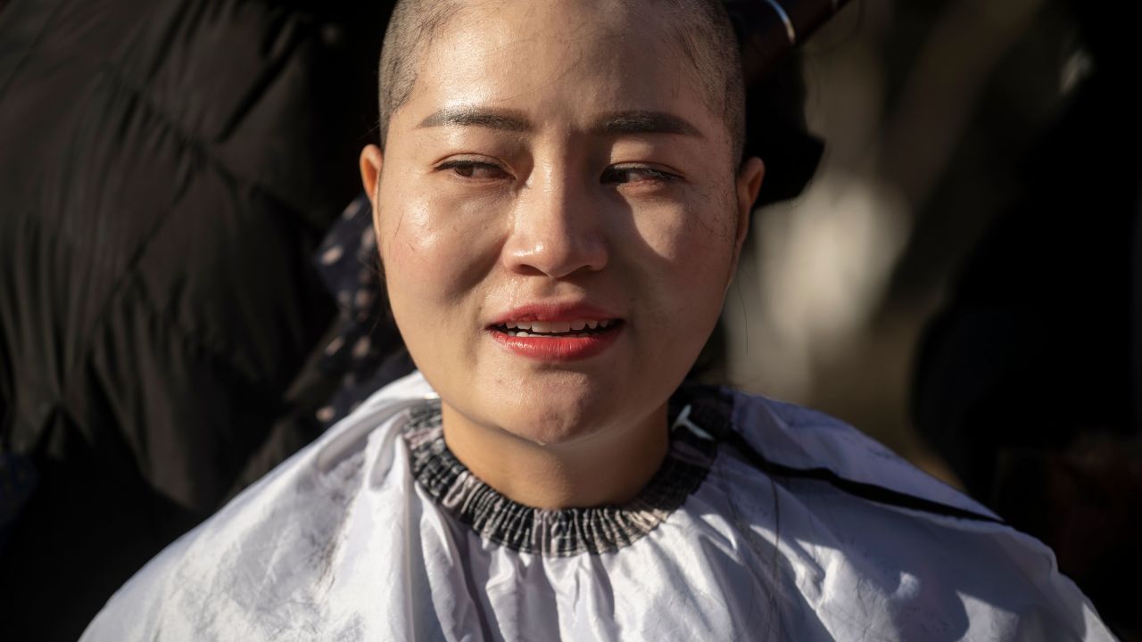 Li Wenzu has her head shaved to protest the detention of her husband Wang Quanzhang in Beijing on December 17.