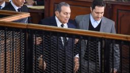 Ex-Egyptian President Hosni Mubarak is escorted Wednesday by sons Alaa, right, and Gamal in court in Cairo.