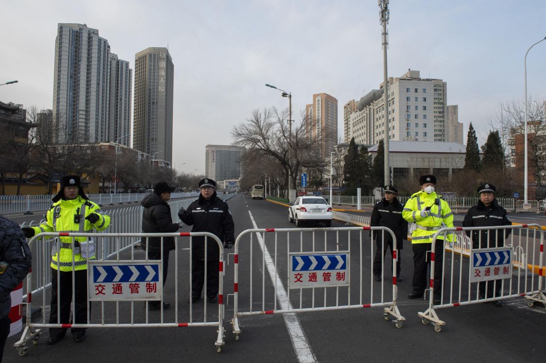 Police officers block streets in front of the number 2 intermediate people's court in Tianjin on December 26.