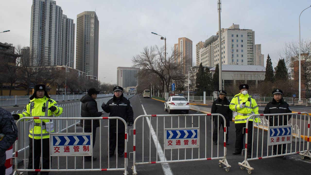 Police officers block streets in front of the number 2 intermediate people's court in Tianjin on December 26.