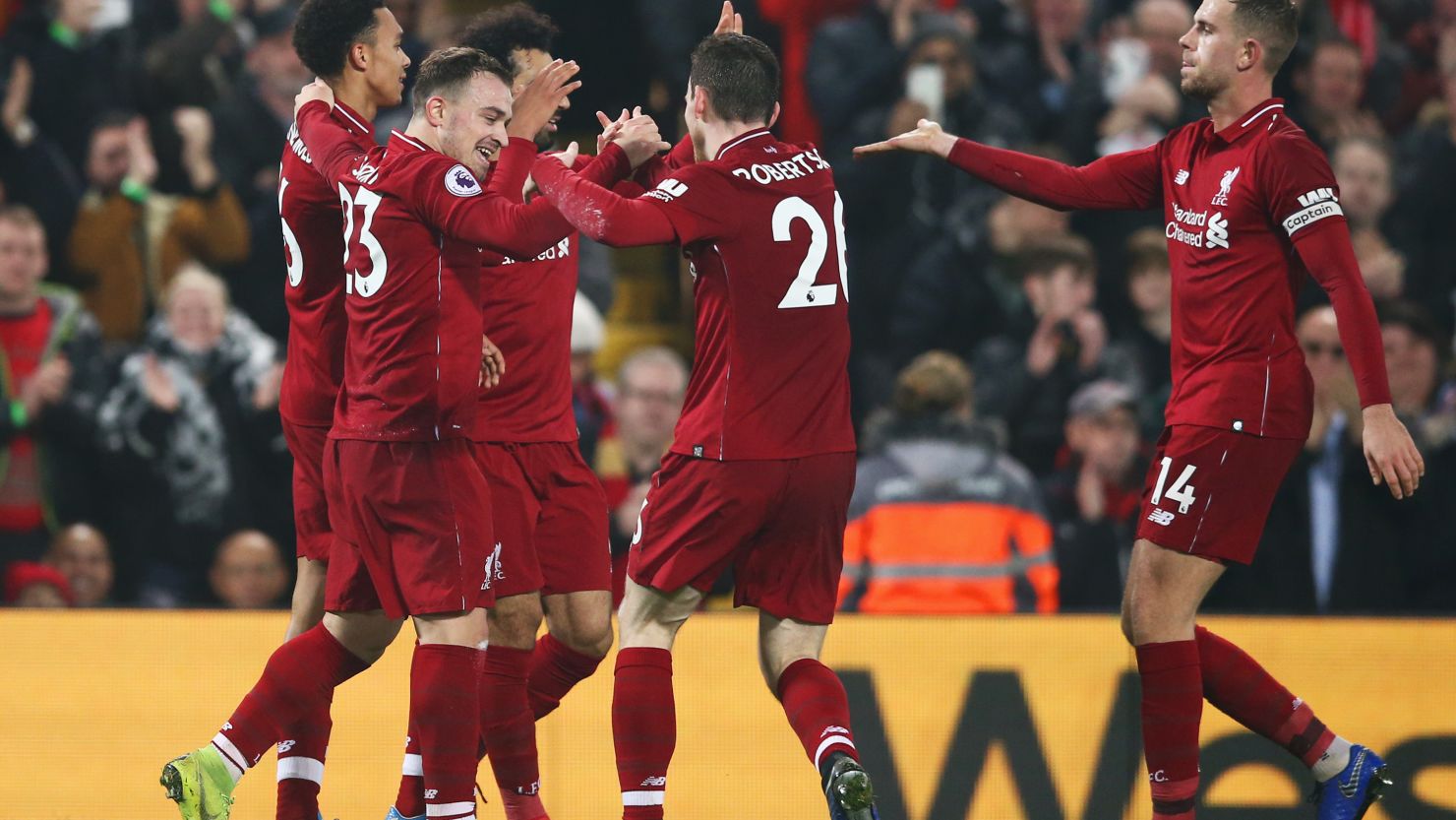 Xherdan Shaqiri (second left) celebrates his team's third goal in the 4-0 home win for Liverpool over Newcastle United.