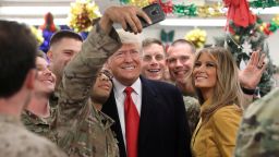 U.S. President Donald Trump and First Lady Melania Trump greet military personnel at the dining facility during an unannounced visit to Al Asad Air Base, Iraq December 26, 2018. REUTERS/Jonathan Ernst     TPX IMAGES OF THE DAY