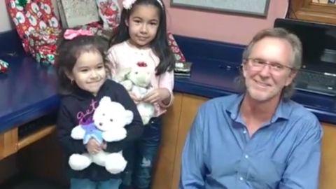 Randy Heiss poses for a photo with Dayami and her 4-year-old sister. 