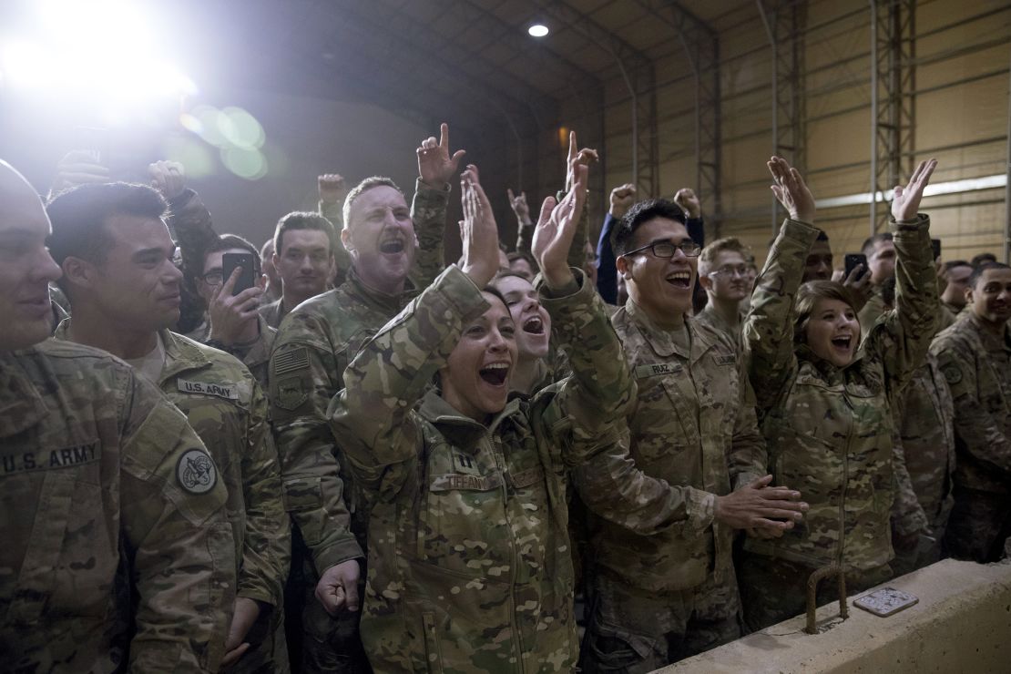 Members of the military cheer as President Donald Trump speaks at a hanger rally at Al Asad Air Base, Iraq, Wednesday, Dec. 26, 2018. President Donald Trump, who is visiting Iraq, says he has 'no plans at all' to remove US troops from the country.  (AP Photo/Andrew Harnik)