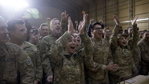 Members of the military cheer as President Donald Trump speaks at a hanger rally at Al Asad Air Base, Iraq, Wednesday, Dec. 26, 2018. President Donald Trump, who is visiting Iraq, says he has 'no plans at all' to remove US troops from the country. (AP Photo/Andrew Harnik)
