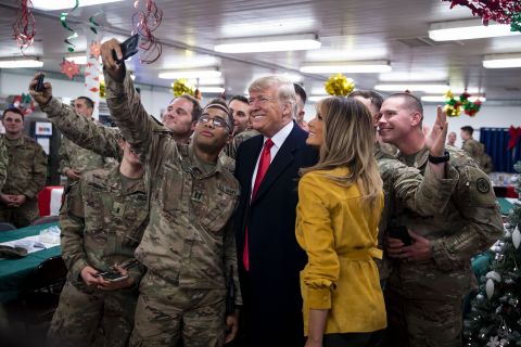 President Donald Trump and first lady Melania Trump greet military personnel at the dining hall during an unannounced visit to Al Asad Air Base in Iraq on Wednesday, December 26.