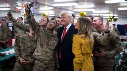 President Donald Trump and first lady Melania Trump take a photo with military personnel in a dining hall at the al-Asad Air Base in Iraq's Anbar province, Dec. 26, 2018. The surprise trip, which came in the midst of a government shutdown, was Trump's first visit to troops stationed abroad in a combat zone. (Al Drago/The New York Times)