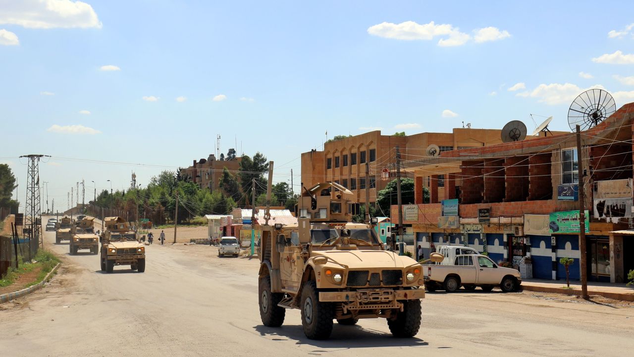 Vehicles of the US-led coalition battling the Islamic State group patrol the town of Rmelan in Syria's Hasakeh province on June 5, 2018. (DELIL SOULEIMAN/AFP/Getty Images)