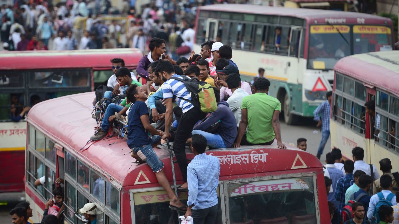Indian applicants for the Uttar Pradesh police constable recruitment written examination sit on the roof of an overcrowded bus as they return home after examination, at civil lines bus stand, in Allahabad on June 18, 2018.