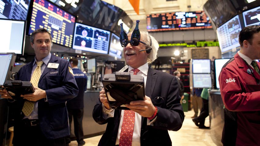 NEW YORK, NY - DECEMBER 31: Traders wear 2013 New Years party glasses while they work on the floor of the New York Stock Exchange December 31, 2012 in New York City. US lawmakers are struggling to work out a last-minute deal to avoid the "fiscal cliff," which could mean tax raises for millions of Americans. (Photo by Allison Joyce/Getty Images)
