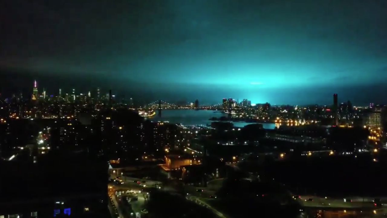 New York's skyline appears in a brilliant blue. The light came as part of an electrical fault that caused an "arc flash," a Con Edison spokesman said.