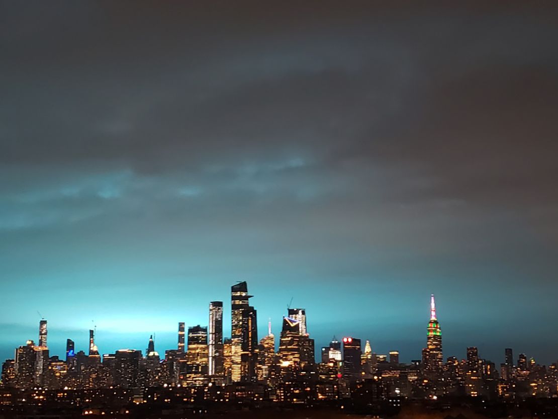 New York's skyscrapers shimmer in a blue glow Thursday night.