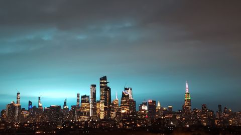 New York's skyscrapers shimmer in a blue glow Thursday night.