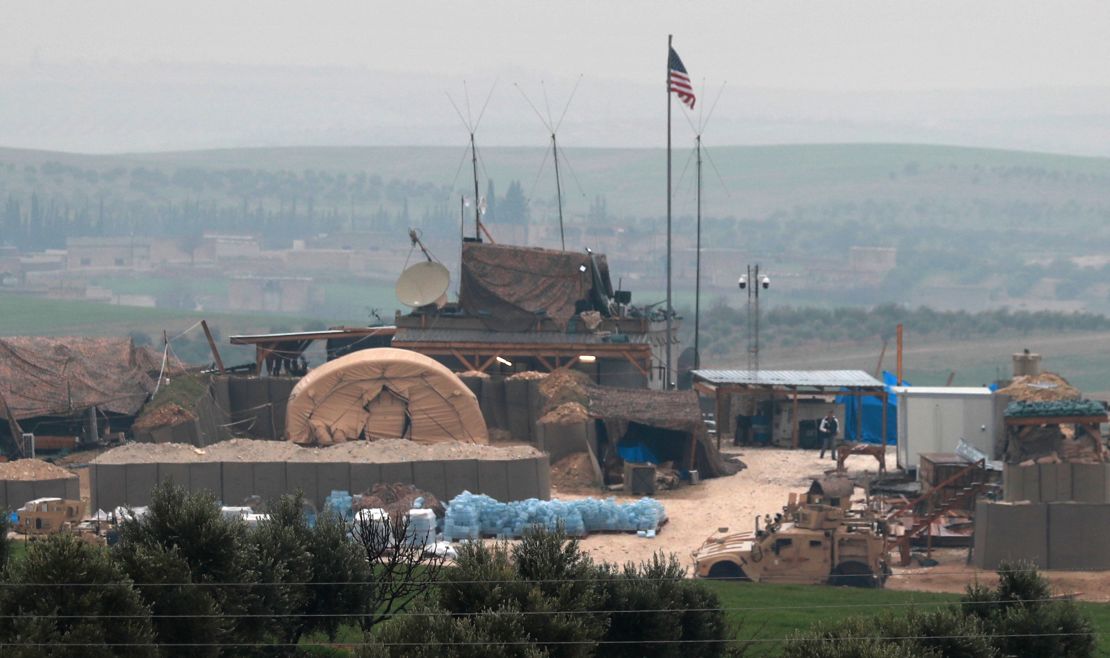 US forces' vehicles and structures are seen Wednesday on the outskirts of Manbij, Syria.